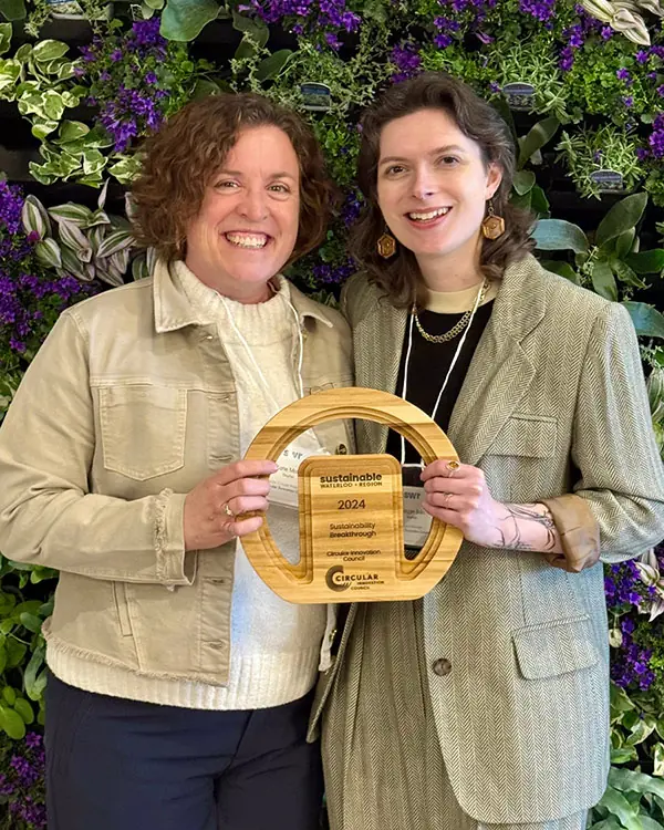 Katie Motta (left) and Maggie Bain (right), Program Directors of Circular Procurement and the Food Waste Program, respectively, accepting the “Sustainability Breakthrough” award for CIC’s Food Waste Program at the Sustainable Waterloo Region Award Event 2025.
