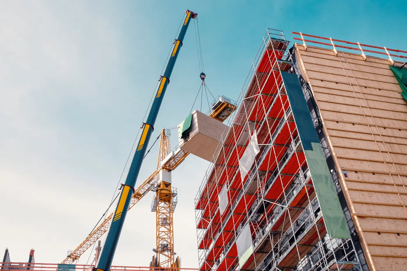 Prefabricated modular timber building being assembled with a crane