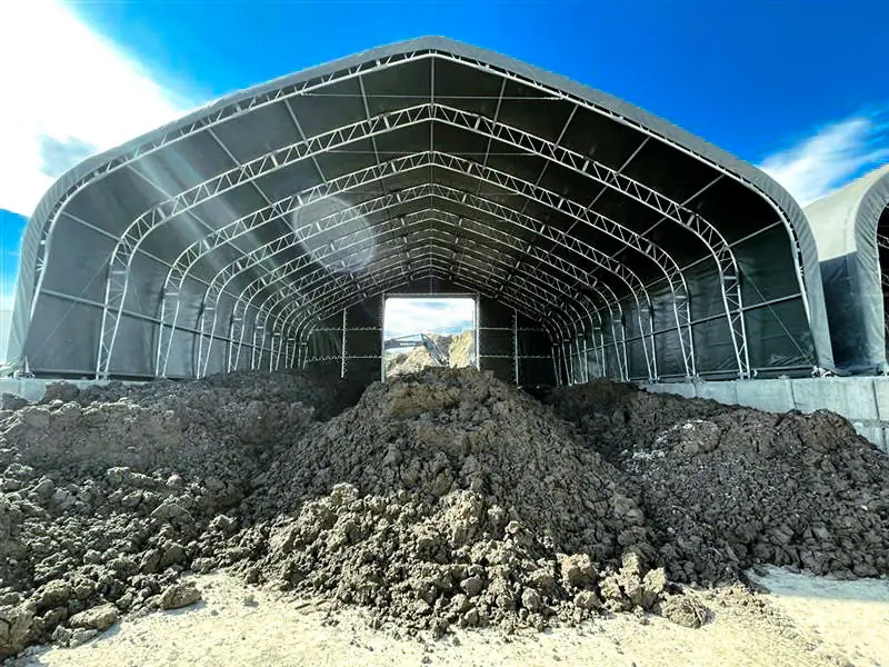 Piles of soil in GRT’s receiving tent, before being loaded into the plant for processing and sorting.
