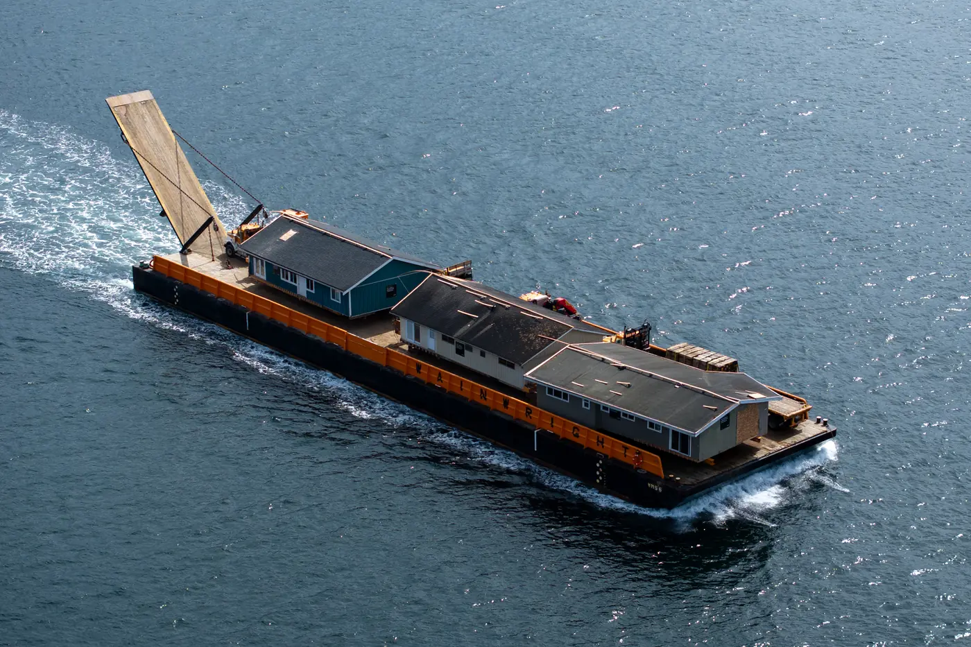 Relocated homes being barged to the shíshálh Nation (photo courtesy of Renewal Development).