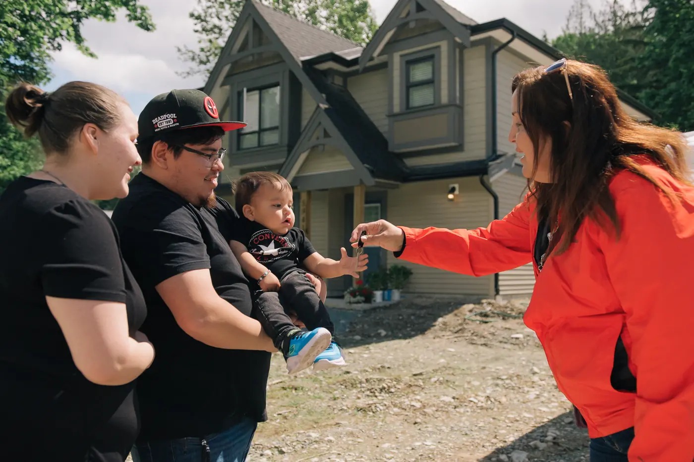 A family receiving the keys to a relocated home (photo courtesy of Renewal Development).