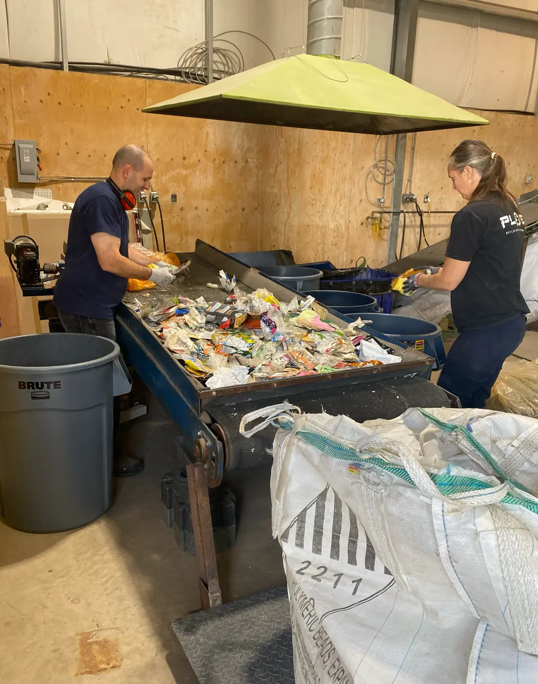 The PLAEX team on the production floor, processing agricultural and marine waste.