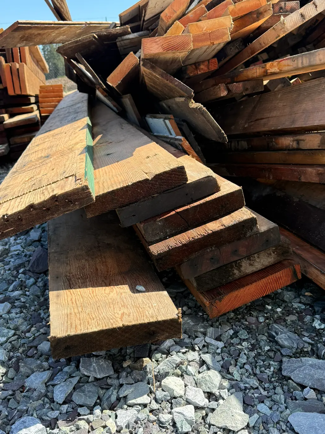 Recovered old-growth lumber awaiting processing and preparation for future reuse projects.